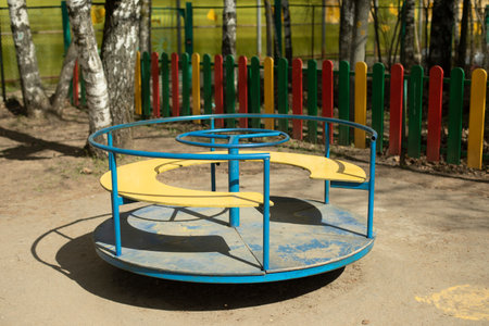 carousel on playground. Empty playground. Attraction for toddlers. Play area in yard.
