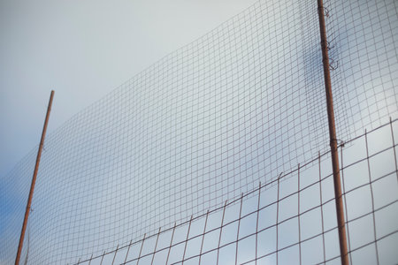 high fence. steel mesh in stadium. Fence from ball. stadium details.の写真素材