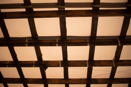 Roof inside. Roof made of planks. interior details. Ceiling in lattice.の写真素材