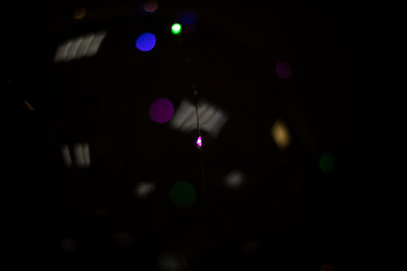 reflection in dark. Lights on plastic surface. Transparent sphere on black background. Ball with LEDs.の写真素材