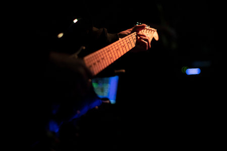 Guitarist playing on the electric guitar in a night club.