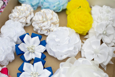 hair ornament. bow on head. fabric decorations. Flap bows. handmade thing. Flowers made of patchwork fabric.の写真素材