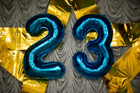 Number 23 balloons. Decoration with numbers. Star of gold hangs on fabric. Festive decoration of hall.の写真素材