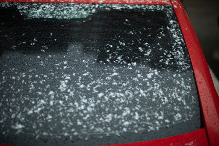 Snow on glass. Snow on car window. after snowstorm. Precipitation on surface. transport details.