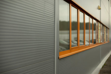 Orange window in building. Details of house. industrial building. Wall surface with window.