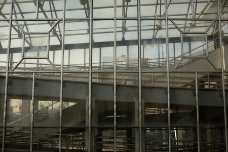 Glass pedestrian crossing building. bridge over road. Interchange. Details of technical structure. Lift above track.の写真素材