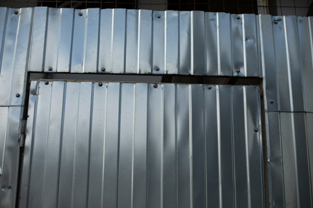 Steel fence detail. Fence made of metal profile. Durable material to protect against prying eyes. Private territory.の写真素材
