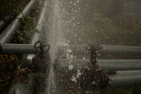 Water pouring out of broken pipe. pipeline breakthrough. Boiler station accident. flow of water.の写真素材