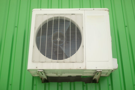 Air conditioning on wall. White air conditioning on building. cooling system. Fan grille.の写真素材