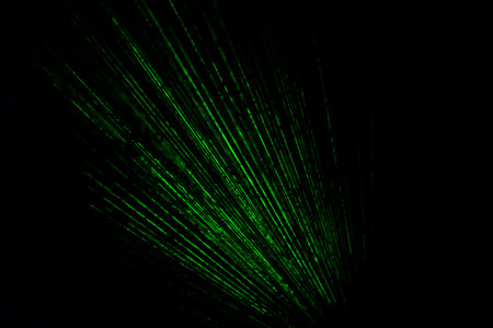 Laser beams in dark. Green rays on black background. Light music bright color. laser radiation.の写真素材