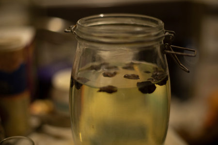 Alcohol in jar. Alcoholic infusion. Nuts float in water. Beverage details.