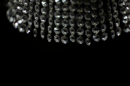 Crystal chandelier on black background. interior details. light in room. light sources. glass sticks. Chandelier details.の写真素材