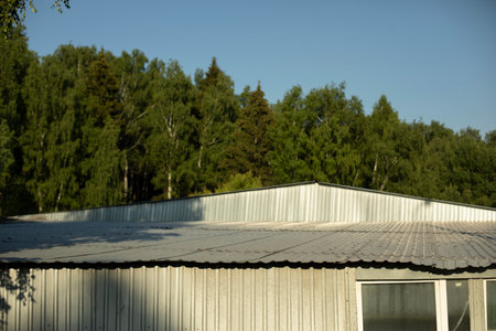 steel profile building. Roof of production hall. Warehouse building outside. house in sunlight.の写真素材