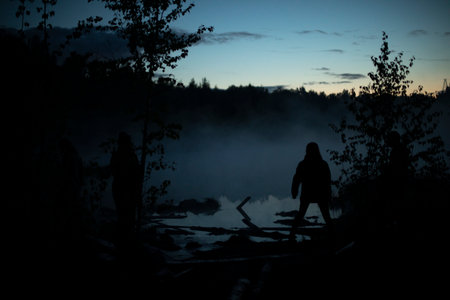 Man in fog on lake. Silhouette of man on shore. outdoor recreation. meeting dawn.の写真素材