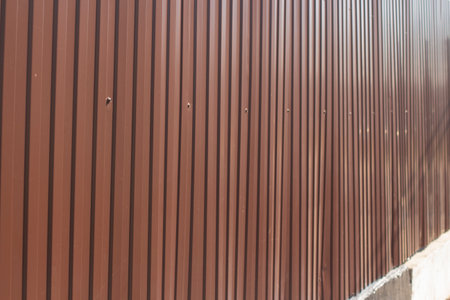 Fence in detail. Fence around house. Barrier for outsiders. Private territory.の写真素材