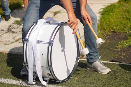 Drum on football. Football fan beats drumsticks into membrane. Details of attributes of football...