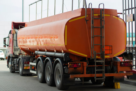 Truck with fuel. Transportation of gasoline. Fuel at the gas station. Truck with fuel tank. Delivery of petroleum products by special transport.の写真素材