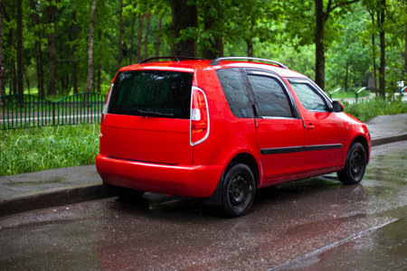 Red car in the parking lot. The car is on the road. Red family car.の写真素材