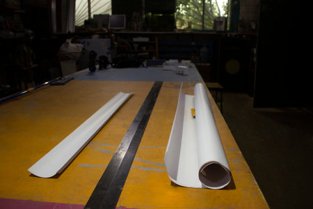 Roll paper. cutting film. big lineup. Table in advertising workshop. Preparation of project.の写真素材