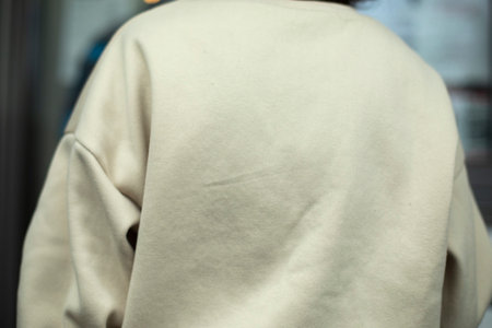White jacket. White sweater. Clothes from back. fabric details.の写真素材