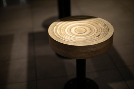 Round seat with wood texture. Chair made of wood. Furniture at fast food point. Details of...