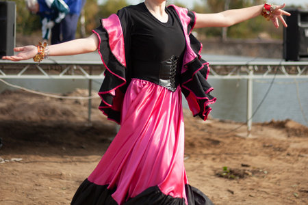 Gypsy dances in bright dresses. Girls dance on street spanish dance. Bright fabric. Dance moves.の写真素材