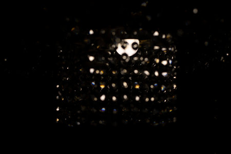 Glass chandelier in dark. Crystal and light. interior details. light in room. Chandelier lamp.