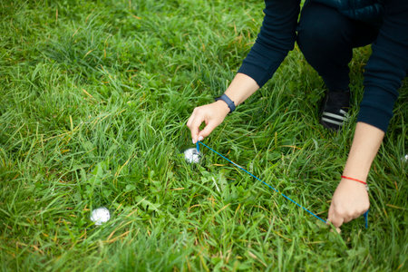 playing on green grass. Game of steel balls. Sports competition for points. girls measure accuracy of projectile.の写真素材