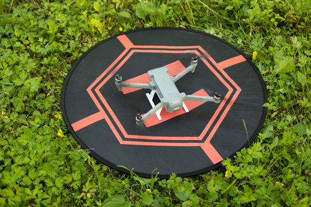 Landing drone in the field. Drone site. flight technology. Four propellers.の写真素材