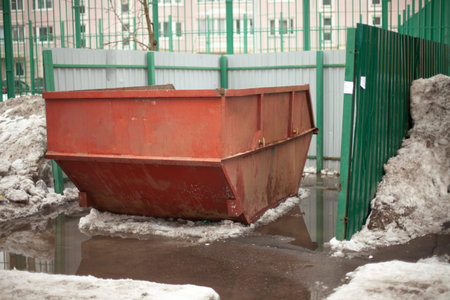 Garbage container. Steel waste tank in the city. Large garbage can in yard. Details of urban...