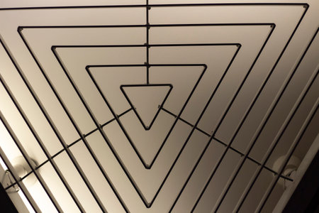 Triangular lamp interior. Design of lighting device. Lamp on ceiling. architecture details.の写真素材