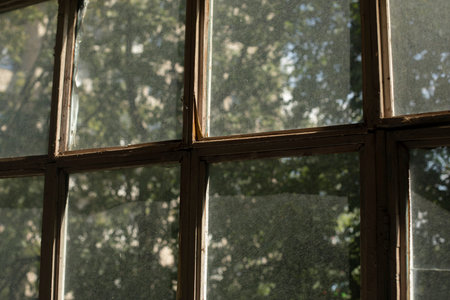 old window frame. glass on window. interior details. Morning light on dusty glass. old housing.の写真素材