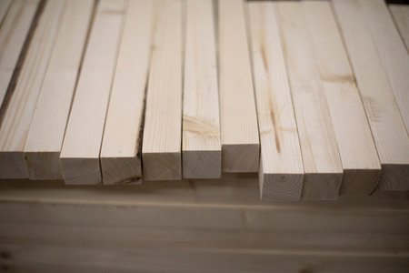 boards in stock. wooden blanks. Bars made of wood of light color. Details of steelwork.の写真素材