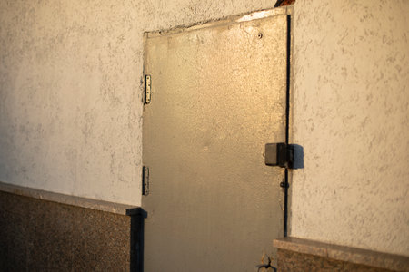 steel door in wall. doorway. Details of technical building. emergency entrance. armored door.の写真素材