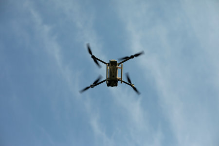 Drone in sky. Quadro copter flies in air. Surveillance from height. Four propellers. flight technology.の写真素材