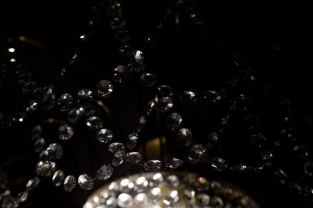 Glass chandelier in dark. Crystal and light. interior details. light in room. Chandelier lamp.の写真素材