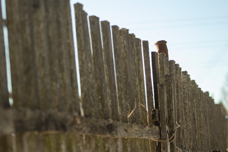 Fence in winter. Fence in countryside. Wooden fence made of old boards.の写真素材