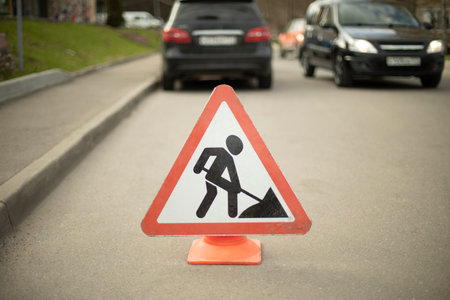 Road sign of road repair. Careful repair. driver warning. Triangular sign on road.の写真素材