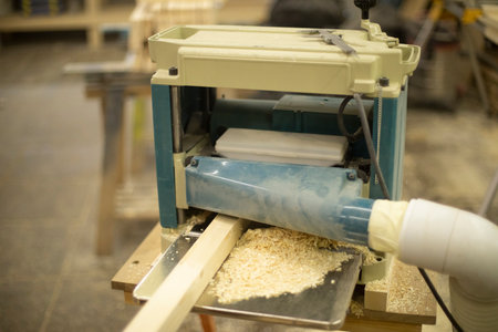 cutting board in wood workshop. Processing of wood bar. Saw off layer. Tool in workshop.の写真素材