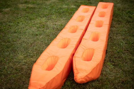 Sports equipment at the stadium. Soft mats for sports game. orange object. Equipment for competitions.の写真素材