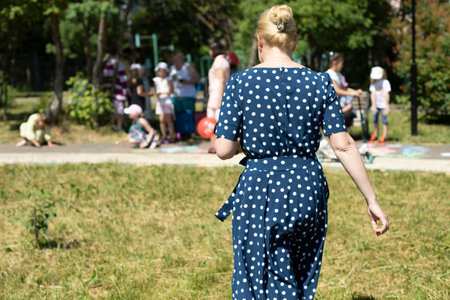 Polka dot dress. woman in the park. girl walking down street. Beautiful woman in summer dress.の写真素材