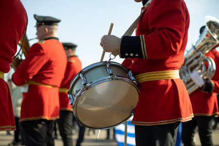Drummer at parade in red clothes. Drumming. percussion musical instruments.の写真素材