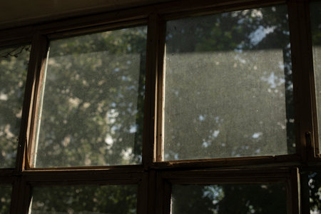 old window frame. glass on window. interior details. Morning light on dusty glass. old housing.の写真素材