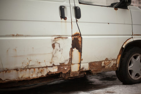 Rusty car bottom. Rust on surface of transport. Old white bus. Transporter of the 90s.の写真素材
