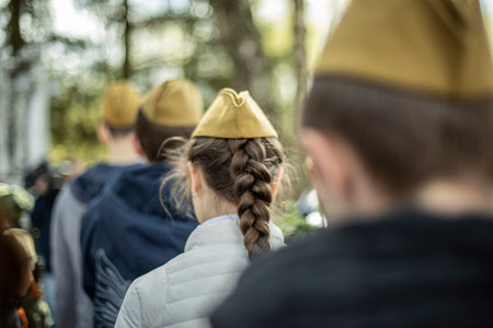 Girls in military uniform in Russia. Mourning ceremony in honor of victory over fascism. Details of memorable military date. Students at Tomb of Unknown Soldier.の写真素材