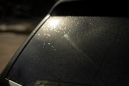 Black car rear window. Drops on rear window of transport. light on car window. Black Machine Parts.の写真素材