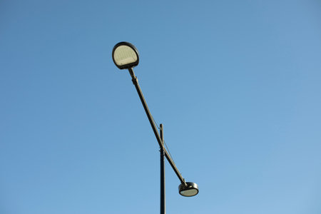 Field with lamp against sky. Lighting fixture in city. infrastructure details.の写真素材