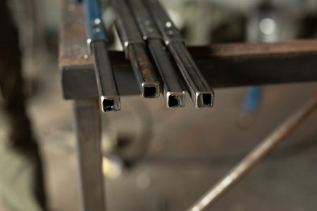 steel parts. Rods made of metal. Details of steel working workshop. polished metal part.