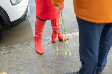 Red boots. Red women's clothing. meeting people. romantic mood.の写真素材