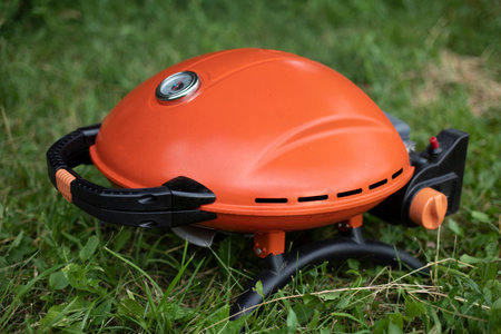 orange grill. Gas grill for frying food. Picnic details. outdoor kitchen.の写真素材